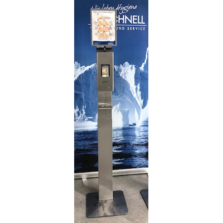 Der Dr. Schnell Edelstahlspender V10 touchless von DR.SCHNELL GmbH & Co. KGaA steht mit einem orangefarbenen Grafikdisplay vor einer blauen Kulisse mit Eisbergen und Wasserbildern.