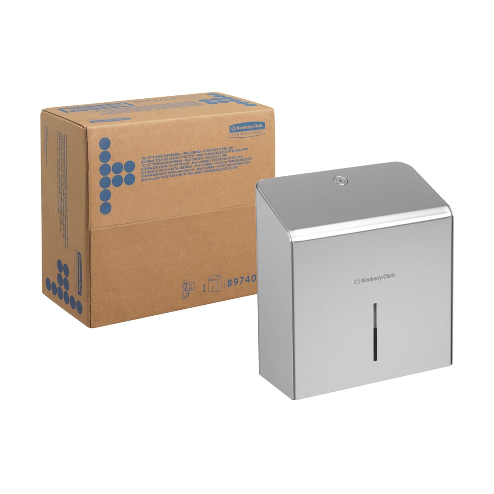En papkasse står ved siden af en Kimberly-Clark Professional™ Mini Jumbo toiletpapirholder (rustfrit stål) fra Kimberly-Clark GmbH, som har et lille vertikalt vindue på forsiden.