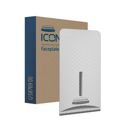 En æske med teksten "Kimberly-Clark™ Icon™ Dispenser Faceplate - FTT" (27,80 x 13,10 x 1,40 cm) fra Kimberly-Clark GmbH er afbildet ved siden af en mønstret faceplate med vertikal åbning, der er ideel til toiletrumsindretning og forsynet med en lille etiket i bunden.