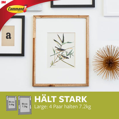 En træramme med botanisk kunst hænger på en hvid væg, fastgjort med Store Command™ Billedophængningsstrips L, 12 sæt i fordelspakke (17206-12) fra 3M Deutschland GmbH - helt uden boring og skadesfrit.