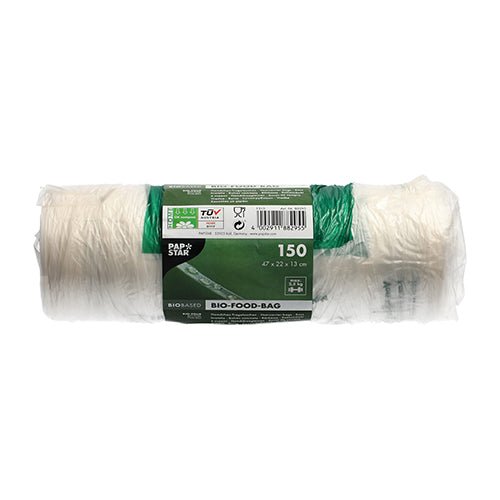 En rulle med 150 PAPSTAR knudeposer (47x22 cm) af gennemsigtig bio-folie fra PAPSTAR GmbH viser et grøn-hvidt bånd med produktinformationer og symboler, der er afbildet ubrugt på hvid baggrund.