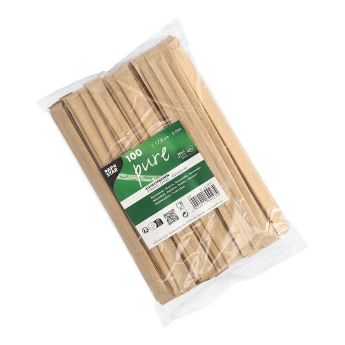 En gennemsigtig plastikpose indeholder 100 PAPSTAR rørepinde træ "pure" 17,8 cm, hver enkelt pakket i folie, hver med en grøn-hvid PAPSTAR GmbH-etiket på forsiden.