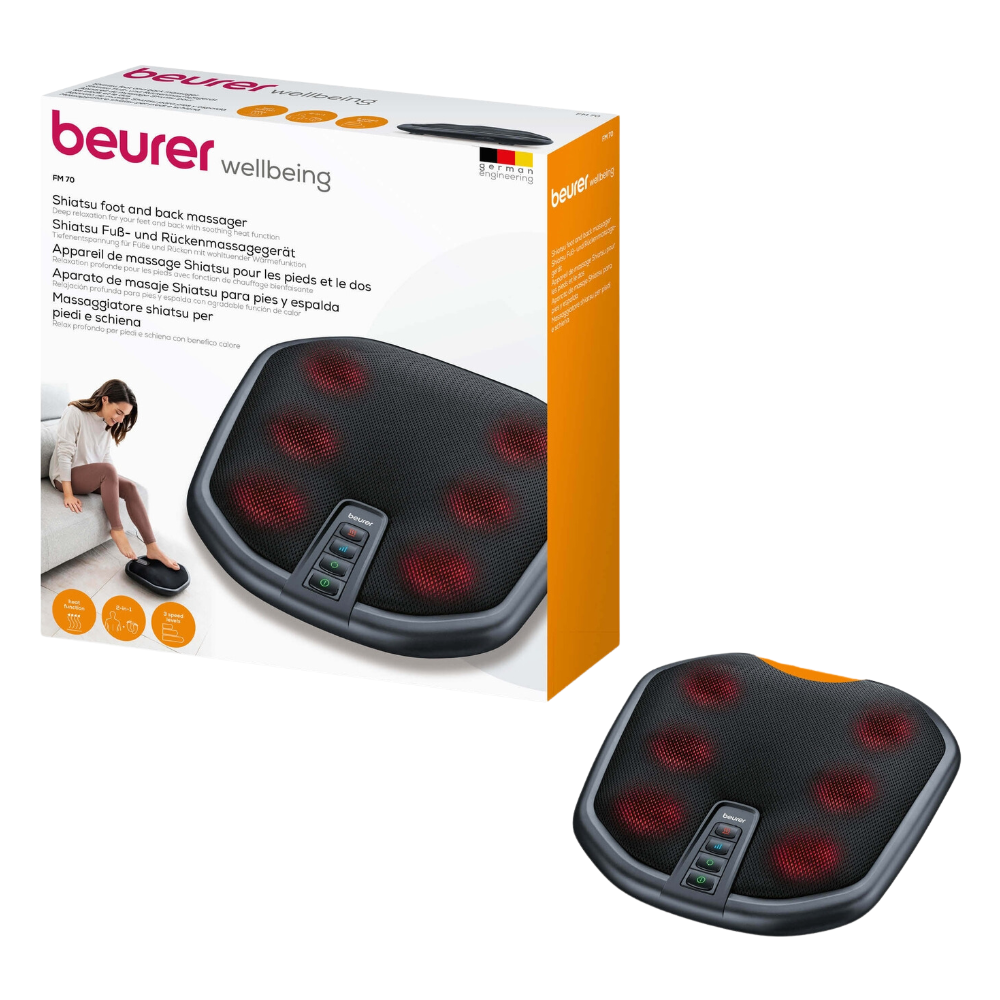 Billedet viser Beurer FM 70 Shiatsu fod- og rygmassageapparat og fremhæver dets valgfri varmefunktion. Den sorte enhed har synlige røde massageknuder og flere betjeningsknapper. Emballagen indeholder et foto af en person, der nyder fod- og rygmassage, samt produktdetaljer på flere sprog.