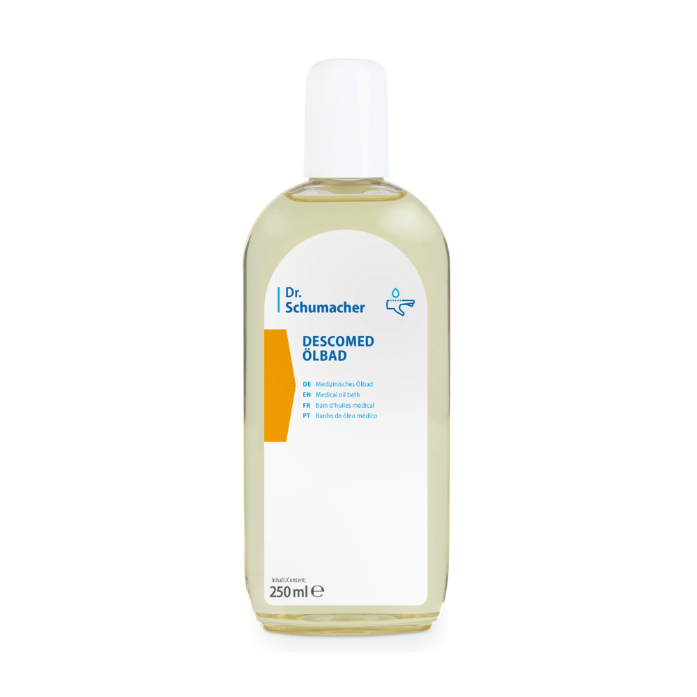 En klar plastflaske med hvidt låg indeholder Dr. Schumacher Descomed olie bad | Flaske (250 ml) fra Dr. Schumacher GmbH. Den flersprogede etiket giver oplysninger om produktet og mængden og er ideel til pleje af tør hud.