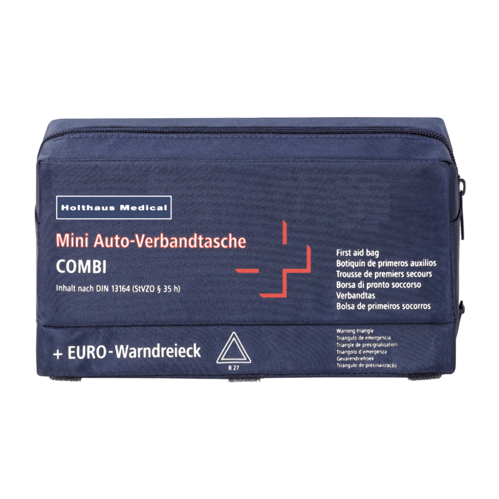 En marineblå førstehjælpstaske med teksten „Holthaus Mini Combi Auto-Verbandtasche“ fra Holthaus Medical GmbH & Co. KG, med et hvidt kors og røde detaljer. Teksten indeholder flere oversættelser af „Erste-Hilfe-Tasche“ og nævner, at indholdet opfylder standarden DIN 13164.