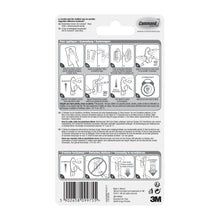 Die Rückseite einer Command™ Kleider-Haken, 17019-FGN-Verpackung der 3M Deutschland GmbH zeigt eine bebilderte Schritt-für-Schritt-Anleitung für die Wandbefestigung ohne Bohren, Warnhinweise, Produktdetails, den Barcode und den 3M Schriftzug in schwarz-weiß.