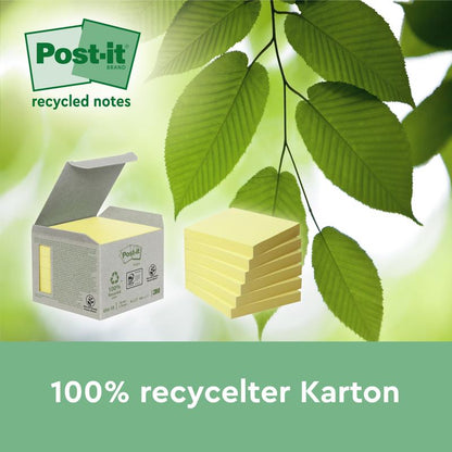 En kasse Post-it® genbrugssedler (38 mm x 51 mm, 100 ark/blok, 100% PEFC) fra 3M Deutschland GmbH ligger åben ved siden af løse sedler med grønne blade i baggrunden. Tekst nedenfor: "100% genbrugskarton.