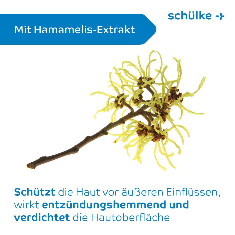 På en hvid baggrund er der afbildet en gren af hamamelis med gule blomster. Teksten lyder »Med hamamelis-ekstrakt« og beskriver på tysk de hudbeskyttende fordele, herunder lindring af hudirritationer. På emballagen til Schülke sensiva® beskyttelsescreme står der »Schülke & Mayr GmbH« med blå skrift.